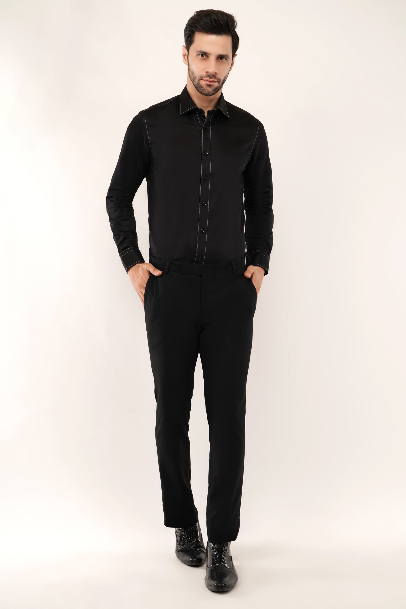 Model showcasing a black designer shirt with silver thread, highlighting its modern fit and premium cotton fabric designed for men.