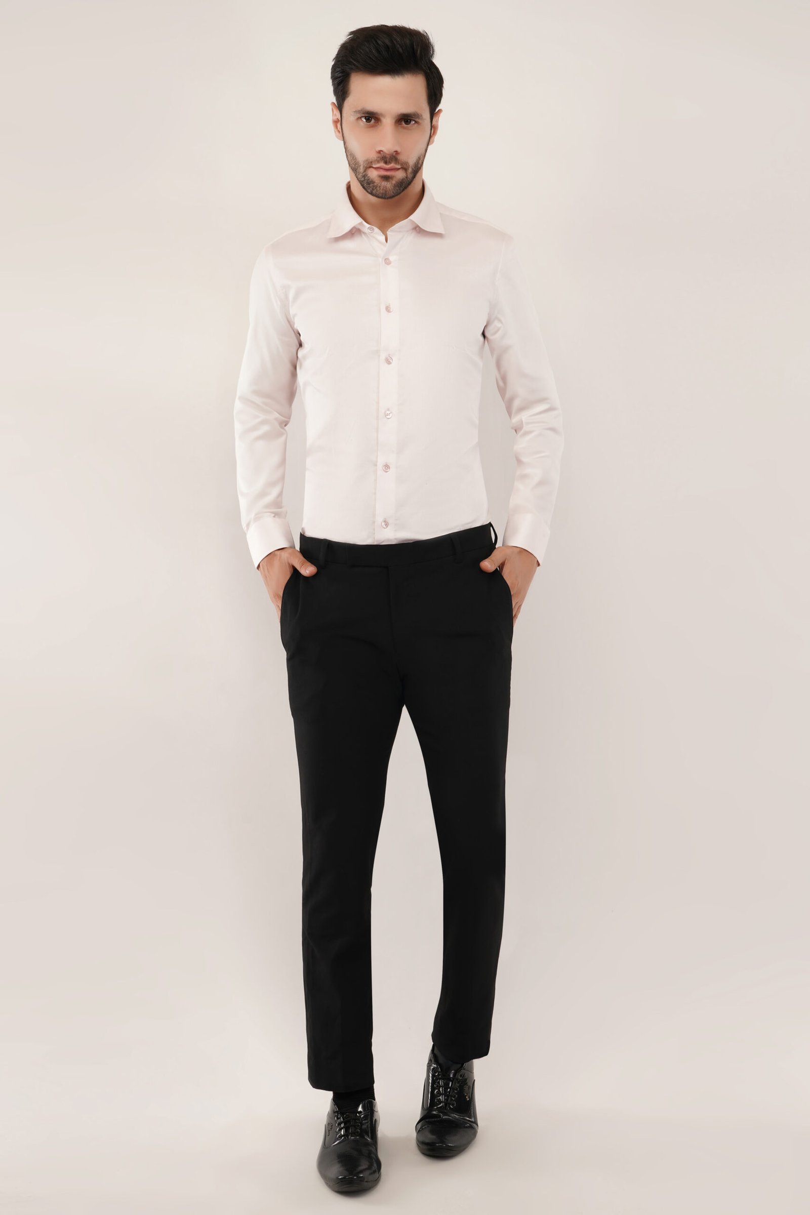 Full-body view of a model in a light pink Giza cotton shirt by Crownberry, paired with black formal pant for a chic, relaxed look.
